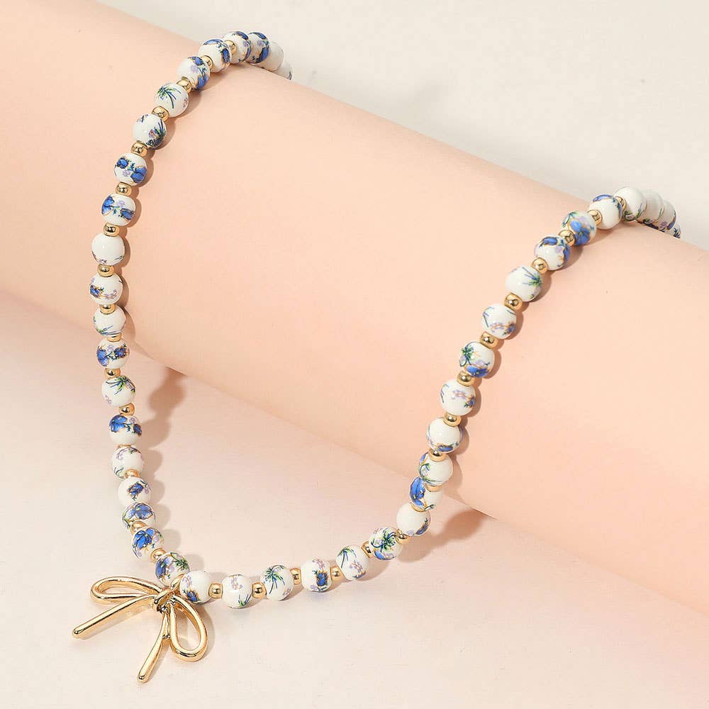 Metal Bow Pendant Floral Printed Ceramic Ball Beaded Necklace