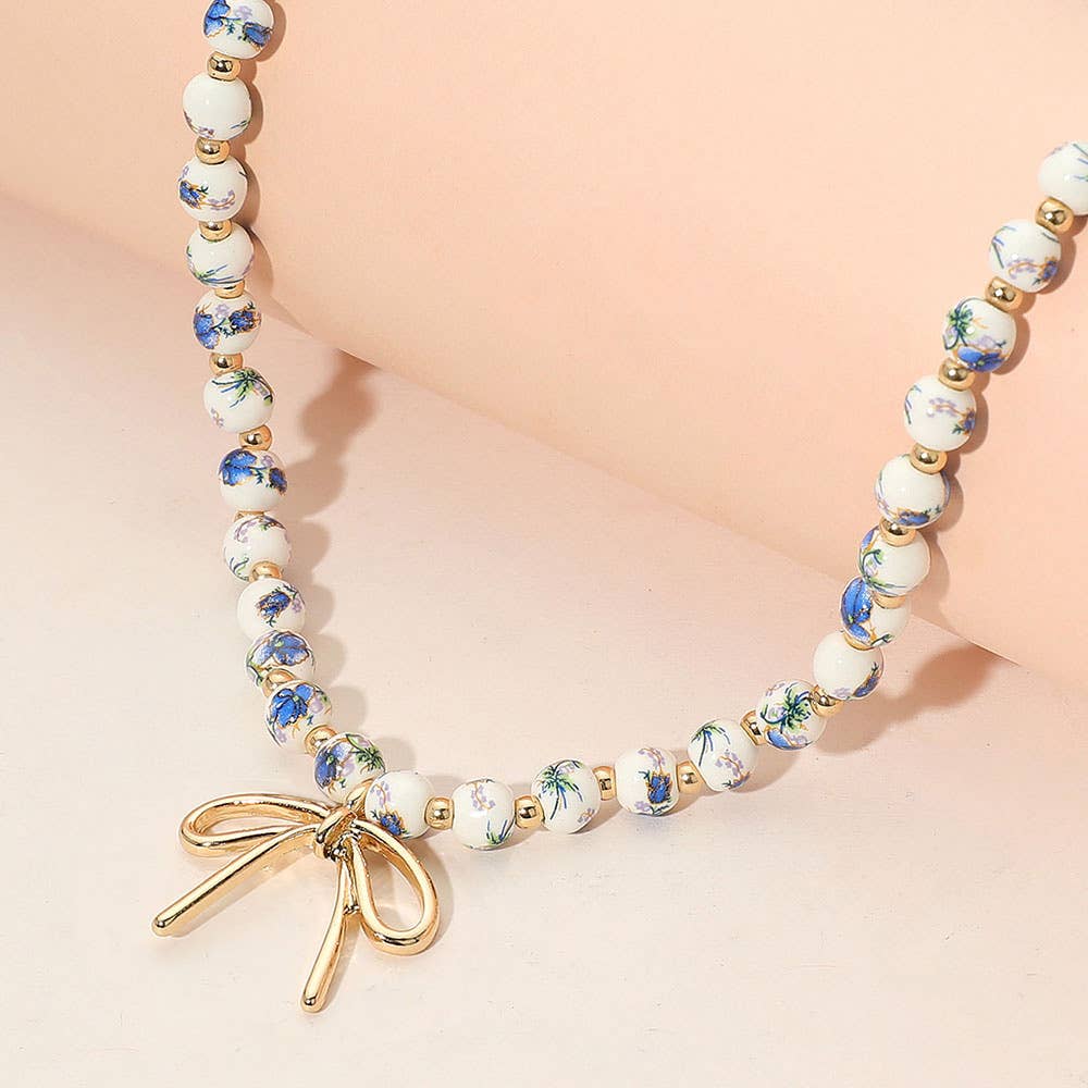 Metal Bow Pendant Floral Printed Ceramic Ball Beaded Necklace